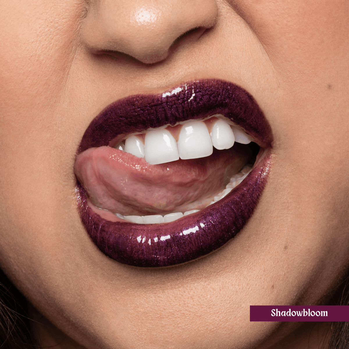 Close-up of a person wearing purple lip oil, color name &