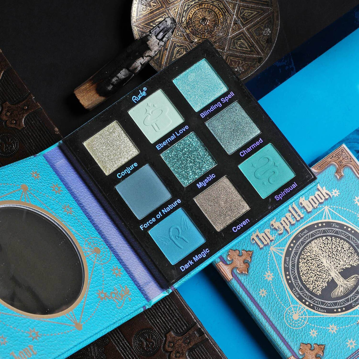 Eyeshadow palette featuring shades of blue on a blue and black background.