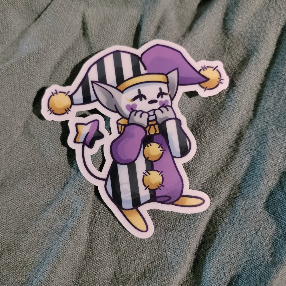 Cartoon character sticker with purple and black stripes on a textured fabric background