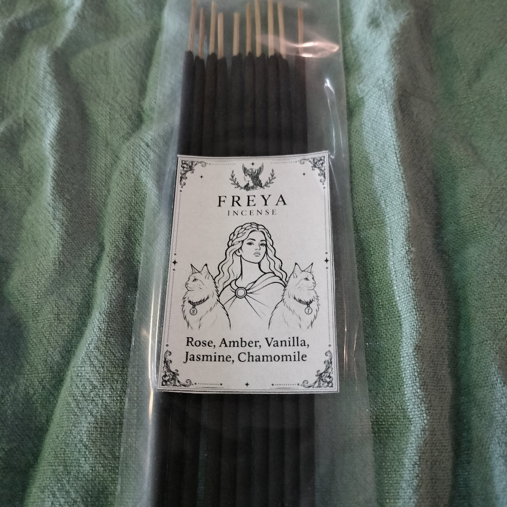 Pack of Freya Incense sticks with a label on a green fabric background