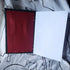 open notebook with red cover and plain white pages on a light background
