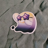 Gradient sticker with a design of a ghost character wearing glasses on a textured gray background