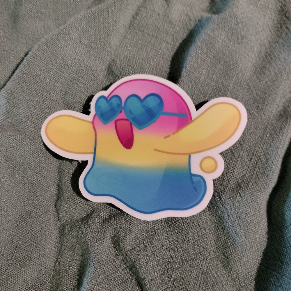 Colorful cartoon character sticker with heart sunglasses on a textured gray background