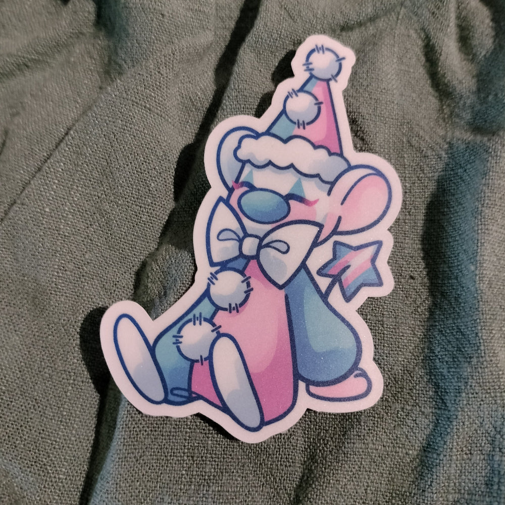 Cartoon character sticker with pastel colors on a textured surface