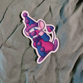 Cartoon character sticker with a purple hat and scarf on a textured gray background