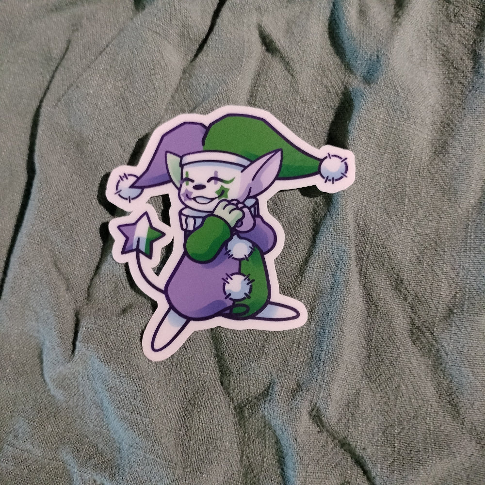 Cartoon character sticker with green and purple outfit on textured fabric background