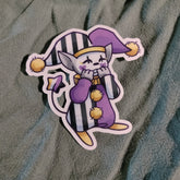 Cartoon character sticker with purple and black stripes on a textured fabric background