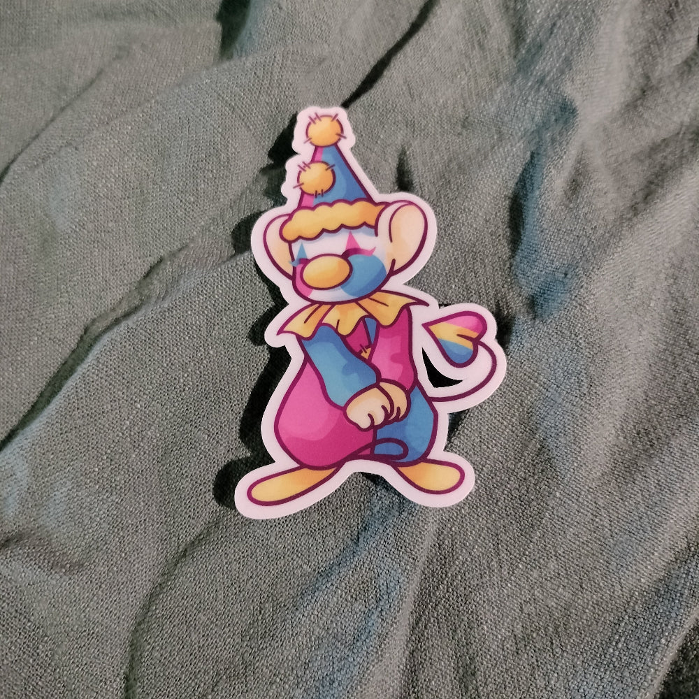 Colorful cartoon character sticker on a textured gray surface