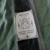 Hecate incense sticks with a label on a green fabric background